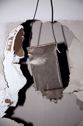 Faraday bag hanging in front of a hole in the wall