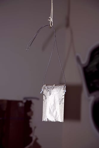 Faraday bag with a toggle hanging from a rope
