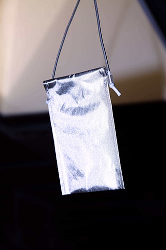 A hanging faraday bag with a flash illuminating it